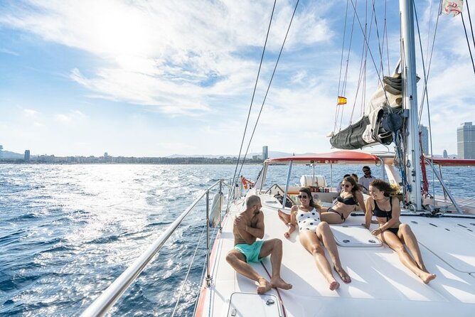 Barcelona Catamaran Cruise with Tapa & Drink Included - Daytime cruise: swimming, sun, and wet decks