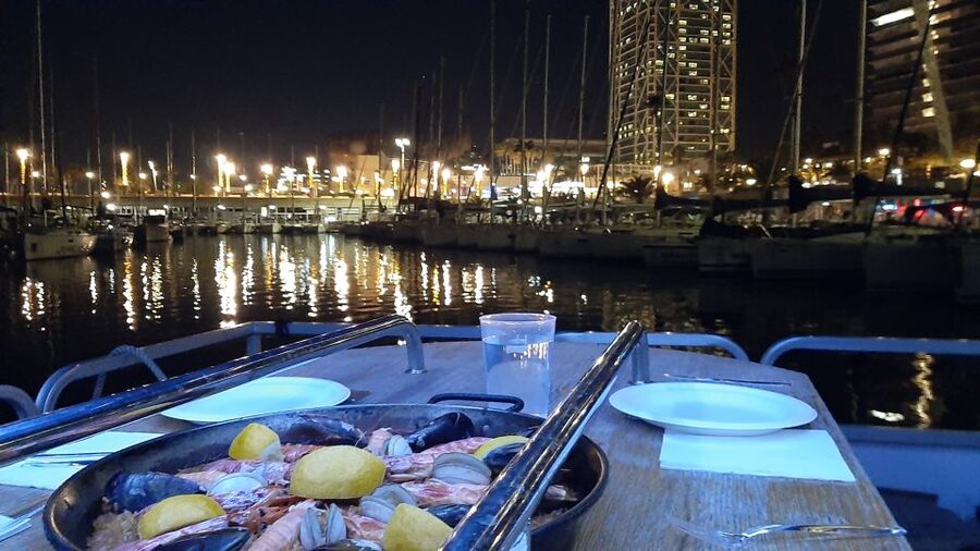 Barcelona: Private Evening Cruise with Dinner and Drinks - A dinner table with Barcelona as the view