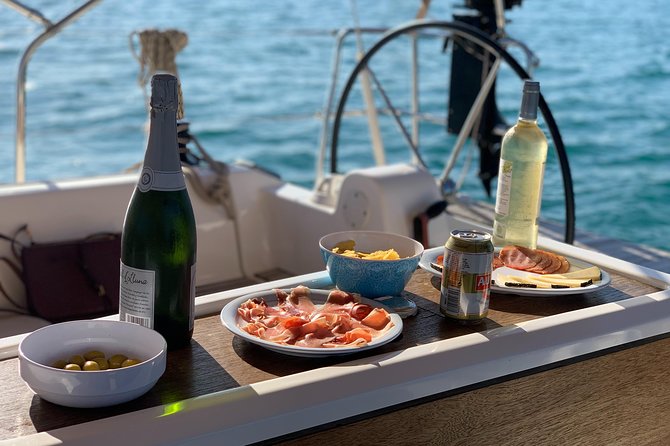 Barcelona Sunset Cruise with Light Snacks and Open Bar - Returning past Barceloneta and Palau de Mar