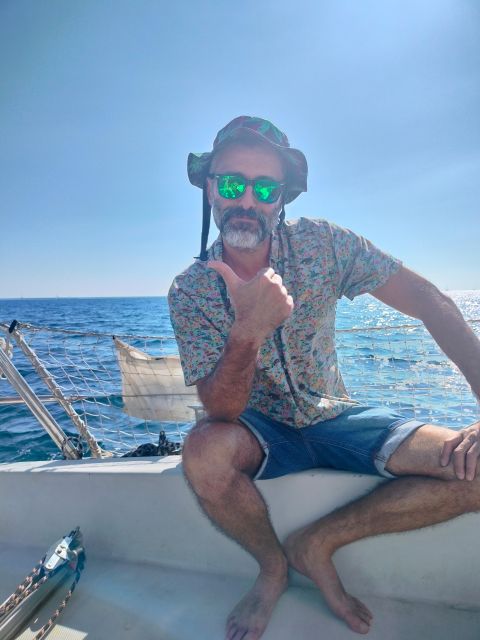 Barcelona: Sunset Cruise with Snacks and Drinks - The skippers and language options