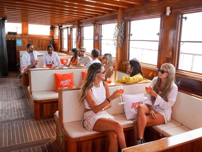 Barcelona: Wooden Boat Sailing with Tapa and Welcome Drink - Music, photos, and the social atmosphere