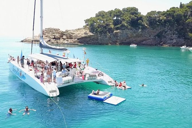 Catamaran trip with other groups along the Costa Brava. Saturday. - The cove stop: swimming, mats, and the trampoline