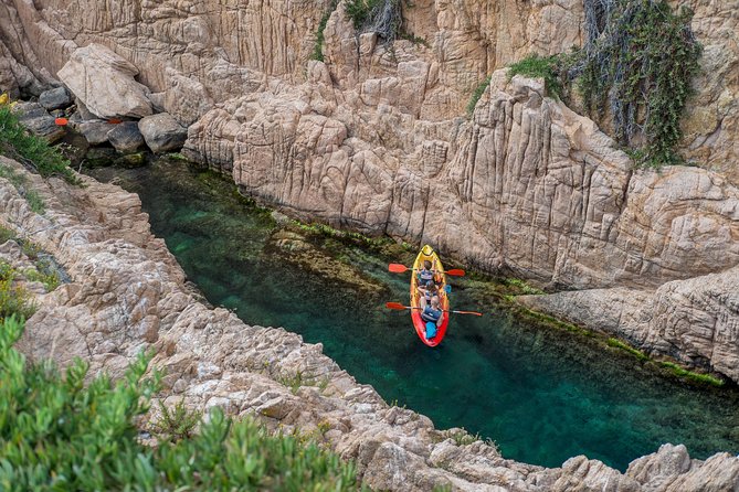 Costa Brava Kayak & Snorkel Tour + Picnic from Barcelona - Paddling along the rocky shore