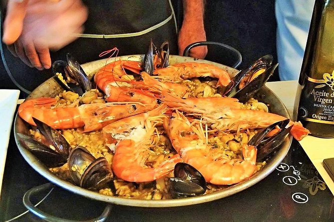 La Boqueria Market and Paella Cooking Class in Barcelona - From Plaça Reial into Barcelona’s food world