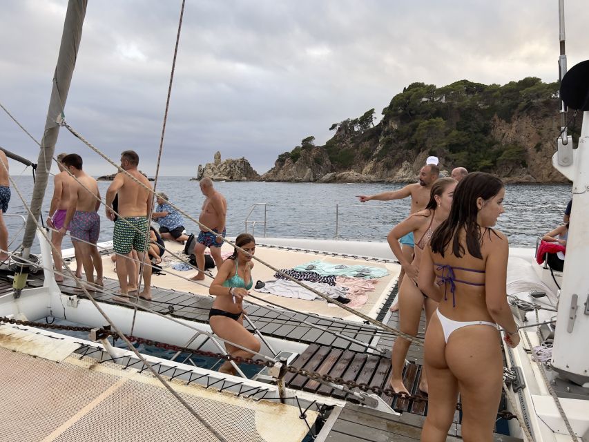 Lloret de Mar: Sunset Catamaran Cruise with DJ and Drinks - Leaving Lloret de Mar by catamaran