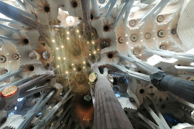 Sagrada Familia and Park Guell Guided Tour with Transport - Inside the basilica beneath the colored light